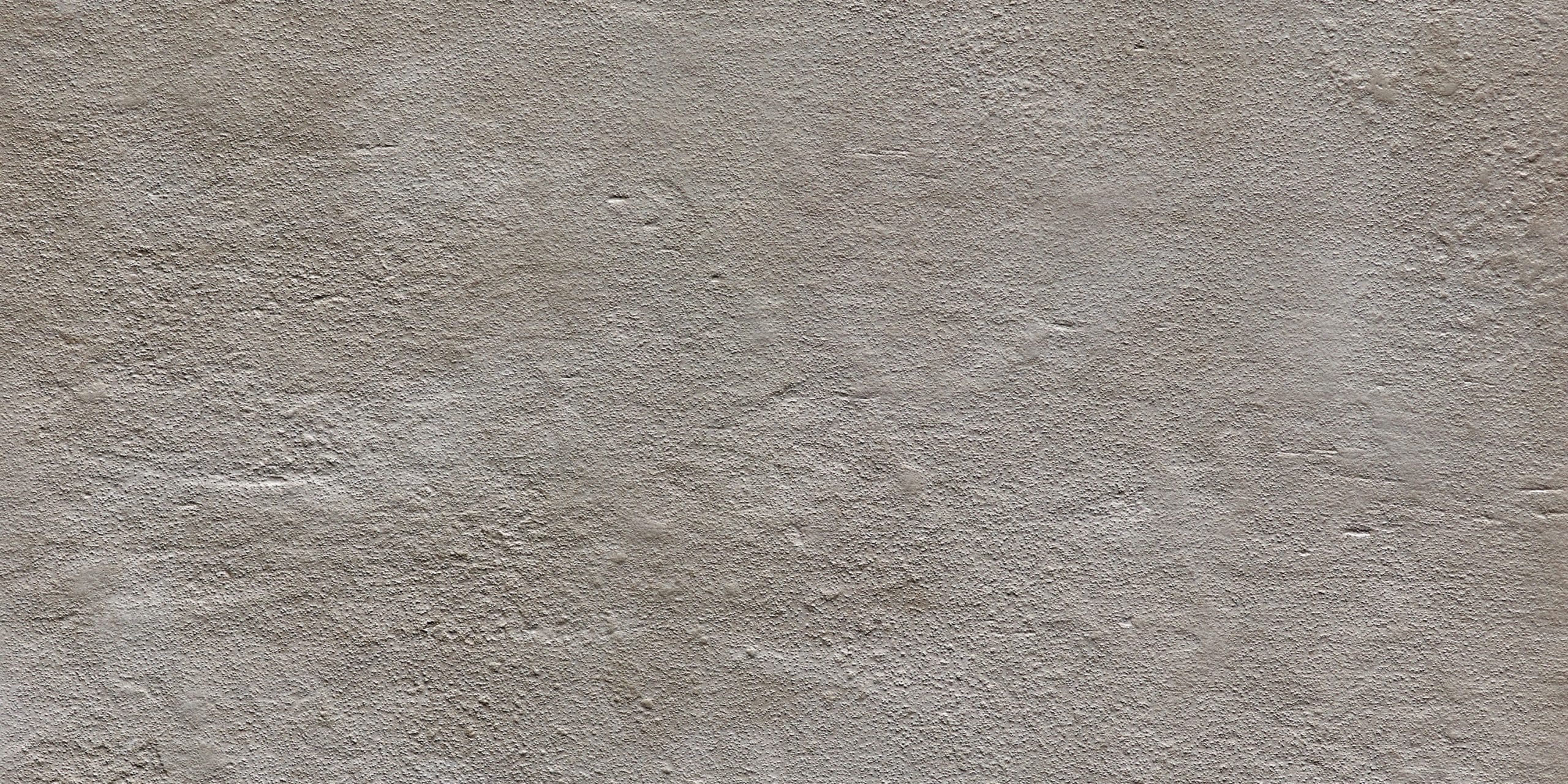 A close-up view of a grey textured ceramic tile with intricate patterns.