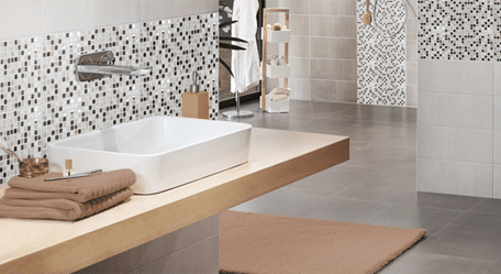 Wet room with tiled walls and floor, featuring a modern and stylish design