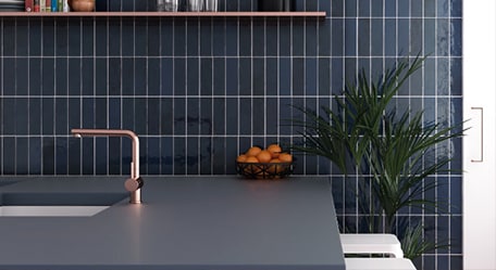 Tile trim bordering three different types of tiles in a home renovation project